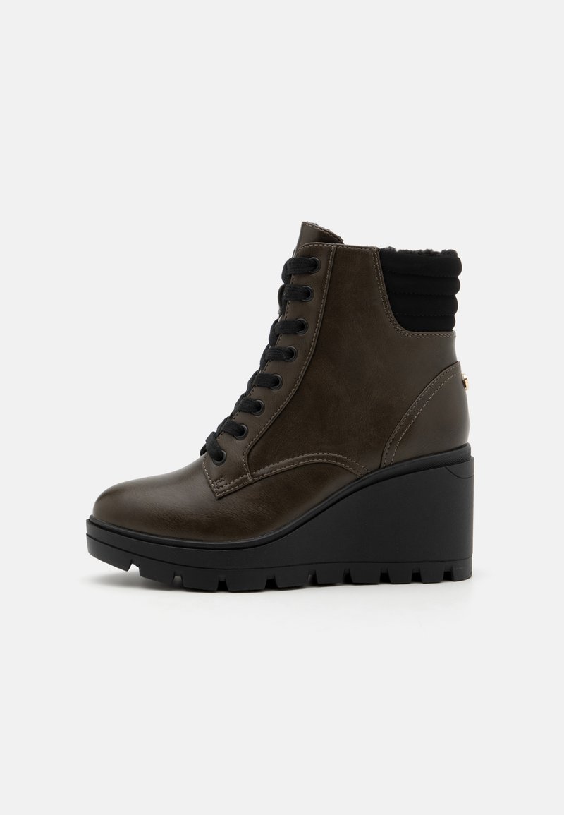 Brown leather ankle boot with a black ribbed collar, lace-up front, and chunky black wedge sole. Features textured accents and smooth finish.