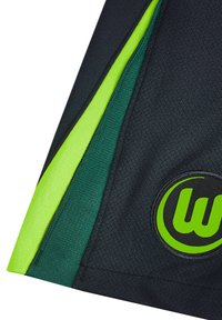Tissu athlétique noir avec des accents latéraux verts et jaune néon. Un logo circulaire avec un "W" stylisé en vert est visible dans la section inférieure.