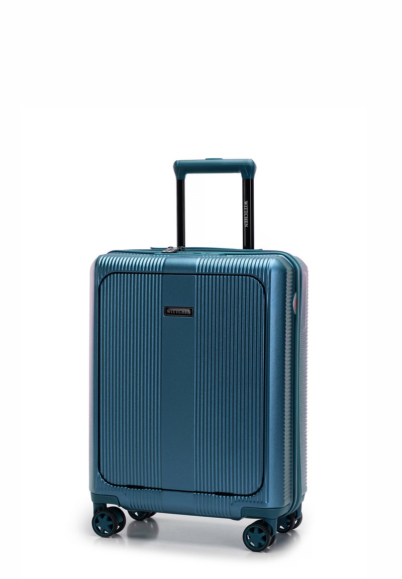 Valigia rigida color verde petrolio con scanalature verticali, manico estensibile e quattro ruote girevoli per la mobilità. Logo del marchio ben visibile.