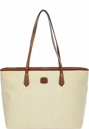 Sac fourre-tout en toile beige avec garniture et poignées en cuir marron, comportant un petit patch logo en cuir embossé au centre avant.