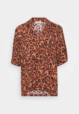 Leopard print shirt in orange and black. Short sleeves, V-neckline, and single chest pocket. Soft fabric with a smooth texture.