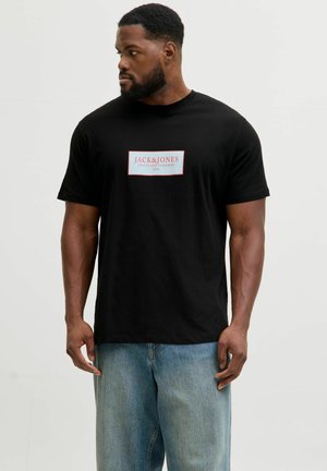 Sort bomulds-t-shirt med et rektangulært hvidt og rødt logomærke, der står "JACK & JONES" og "CREATIVE DEPT. COPENHAGEN" på fronten.