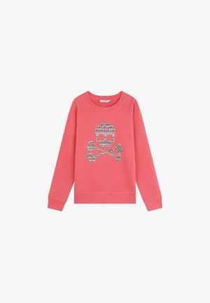 Sudadera de color coral con cuello redondo y mangas raglán. Presenta un gráfico de calavera y tiburones en plata. Textura de tela suave.
