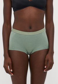 Mint green boxer briefs with a soft, stretchy fabric. Features a wide elastic waistband with "BJÖRN BORG" text. Simple, no additional patterns.