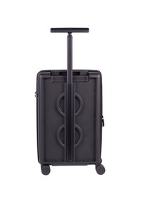 Black wheeled suitcase with a retractable handle, textured surface, circular design accents, and four caster wheels for mobility.
