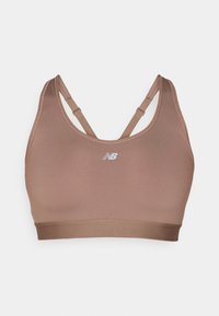 Soutien-gorge de sport dans une teinte brune atténuée, fabriqué en tissu lisse. Dispose de bretelles croisées réglables et d'un logo au centre à l'avant.