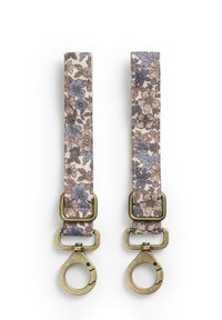 Kukkatyyliset kangaspanelit vaalean kerma-, ruskea- ja sinisävyisinä, metallisine osineen; päässä on kaksi pyöreää klipsiä kiinnittämistä varten.