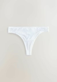 String blanc pour femme avec détails en dentelle florale à la taille, présenté à plat sur un fond clair.