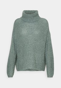 Pull en tricot de couleur vert doux, avec un col cheminée haut, des manches larges et une coupe ample. Tissu texturé avec des variations subtiles.