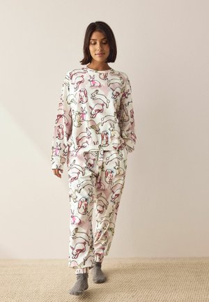 Long-sleeve pajama set in soft fabric featuring a light pink background with colorful cartoon bunnies, matching elastic waist pants.