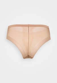 Beige sheer panties with a smooth texture and soft elastic waistband, featuring a seamless design and minimal stitching at the back.