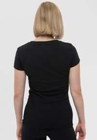 Black short-sleeve T-shirt made of soft fabric, featuring a round neckline and a fitted shape, with a smooth texture and minimal design.