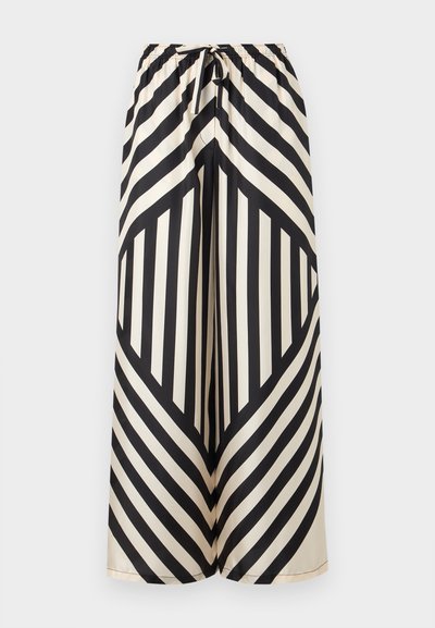 Παντελόνια με φαρδιά μπατζάκια, μαύρες και λευκές διαγώνιες και κάθετες ρίγες, ελαστική μέση και δέσιμο μπροστά.