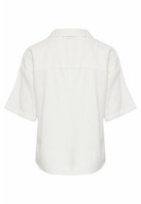 Chemise blanche à manches courtes avec col droit vue de dos, présentant une coupe ample et un ourlet légèrement arrondi.