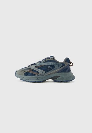 Blue and gray lace-up athletic shoe with mesh panels, textured sole, and Lacoste crocodile logo on the side.