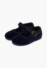 Un par de zapatillas Mary Jane de terciopelo azul oscuro con un broche lateral y suelas de goma, diseñadas para niños.