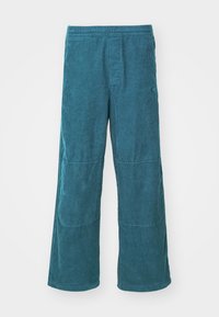 Teal corduroy wide-leg pants with an elastic waistband, featuring vertical ribbing and two side panels. Soft texture with a casual fit.