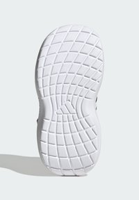 Semelle de chaussure avec une surface en caoutchouc blanc texturé, présentant un motif en losanges et en grille pour l'adhérence. Forme arrondie avec paroi latérale.
