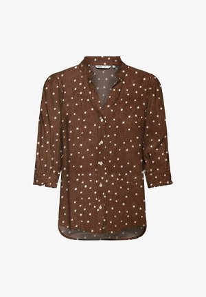 Blouse marron à manches longues avec des pois blancs, col en V avec des boutons sur le devant et des poignets légèrement froncés.