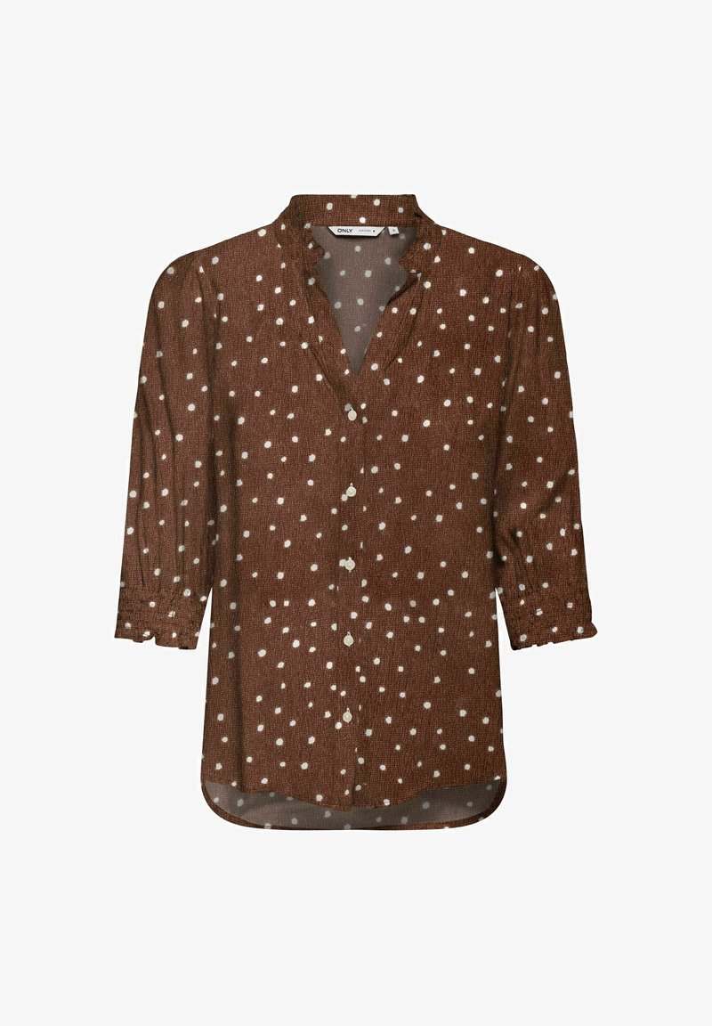 Blouse marron à manches longues avec des pois blancs, col en V avec des boutons sur le devant et des poignets légèrement froncés.