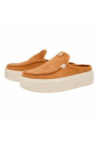 Tan suede slip-on shoes with a rounded toe, raised white platform sole, and subtle stitching details. Features a small logo tag on the upper.