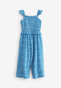 Combinaison florale bleue avec des bretelles à volants, un bodice smocké et des jambes larges. Présente un petit motif floral blanc et jaune. Tissu léger.