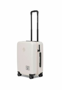 Valise rigide de couleur blanc mat, équipée d'une poignée rétractable noire, de quatre roues noires et d'une poignée latérale. Comprend un mécanisme de verrouillage.