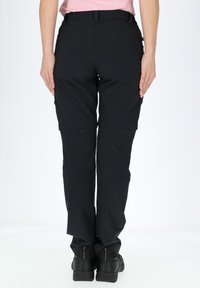 Black, lightweight, stretchable pants with a fitted waist and zippered cuffs. Smooth texture, designed for ease of movement.