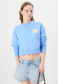 Tommy Jeans HOT PANT - Denim shorts - denim light