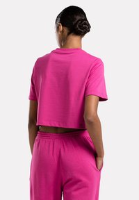 Reebok CROP TEE - Camiseta estampada - semi proud pink