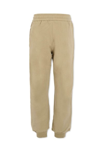 Beige joggingbroek gemaakt van zachte stof, met een elastische tailleband, zijzakken en ribbels bij de enkels.