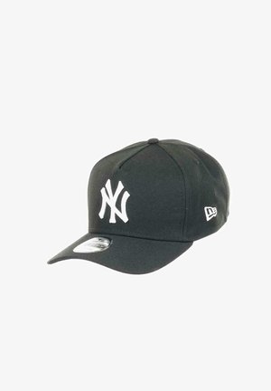 Schwarze Baseballkappe aus Stoff mit einem weißen New York Yankees-Logo auf der Vorderseite und einem gebogenen Schirm. Enthält ein kleines Logo an der Seite.