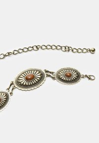 Armband im antiken Stil mit drei ovalen Gliedern mit erhabenen Mustern, jedes verziert mit einem zentralen braunen Stein in einer metallischen Oberfläche.
