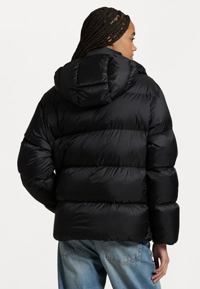 Black puffer jacket with a hood, featuring a quilted design, glossy finish, and elastic cuffs. The model is seen from behind.