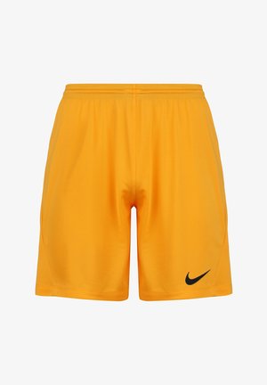 Short de sport jaune vif avec une taille élastique et un logo Nike noir sur le bas de la jambe gauche, présenté sur fond blanc.