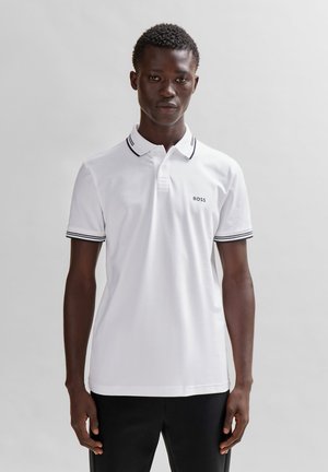 White polo shirt with black accent stripes on the collar and sleeves. Features a small "BOSS" logo on the chest. Made of a smooth fabric.