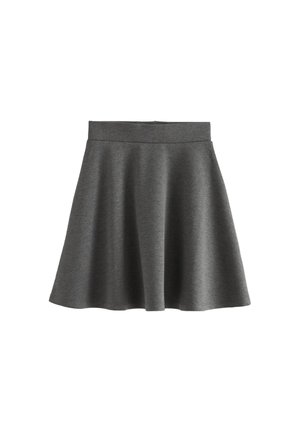 Weißes Kurzarm-Hemd mit Knöpfen und Falten, kombiniert mit einem grauen A-Linien-Rock. Schwarze Strumpfhosen und glänzende schwarze Schuhe runden das Outfit ab.