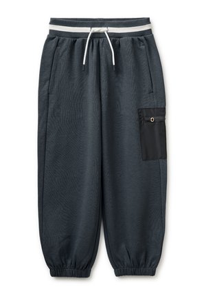 Pantaloni della tuta grigio scuro con polsini elasticizzati, vita con coulisse bianca, tasche laterali e tasca nera con zip sulla gamba destra.