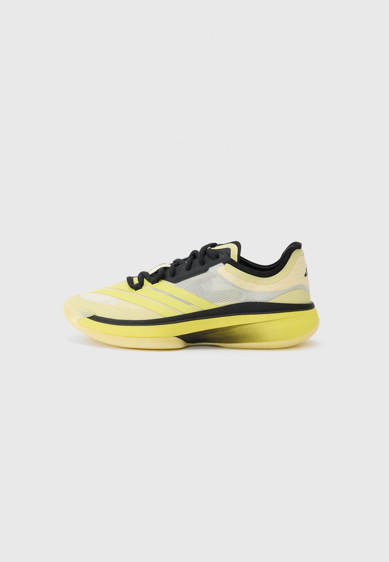 Luminous yellow athletic shoe, mesh upper with black accents, reinforced sole, low-cut design, textured pattern on toe, and flat laces.