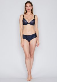 Navy lace bra and matching brief. Bra features adjustable straps and a floral pattern. Brief has a smooth texture and elastic trim.