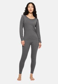 Szary długi rękaw top i pasujące legginsy z gładkiego, elastycznego materiału. Posiada zaokrąglony dekolt i dopasowane mankiety. Prosty design.