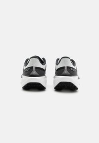 Black and grey athletic shoes with a breathable mesh upper, GORE-TEX branding, and textured white sole featuring a rugged tread pattern.