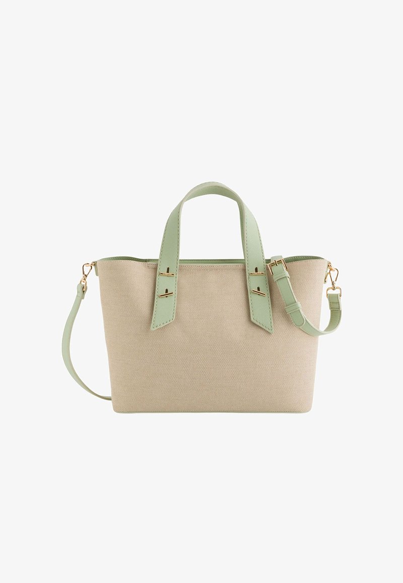 Beige plátěná kabelka s mintovými koženými uchy, odnímatelným popruhem a zlatými kovovými detaily. Má strukturovaný design.