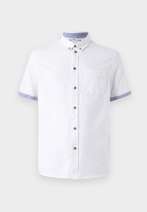 Camicia bianca a maniche corte con chiusura a bottoni, colletto e polsini di colore blu chiaro a contrasto, taschino sul petto e bottoni marroni. Tessuto strutturato.