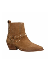 Brown suede ankle boot with pointed toe, decorative silver studs, and a strap around the ankle. Low stacked heel with ribbed detailing.