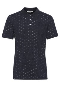Polo à manches courtes bleu marine avec de petits symboles abstraits blancs et une patte à trois boutons.