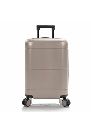 Silver hard-shell suitcase with a textured finish, extending handle, and four black wheels. The brand name "HEYS" is embossed on the front.
