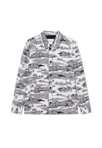 Giacca a motivi in bianco e nero con colletto, chiusura con bottoni e due tasche laterali. Il design include immagini di paesaggi.