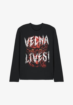 Black long-sleeve shirt with a fiery red demonic face and yellow eyes, overlaid by bold white text reading "VEGNA LOVES!"