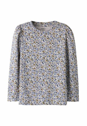 Kinderbloes met lange mouwen en een dicht patroon van kleine blauwe, gele en zwarte bloemen op een lichte achtergrond.